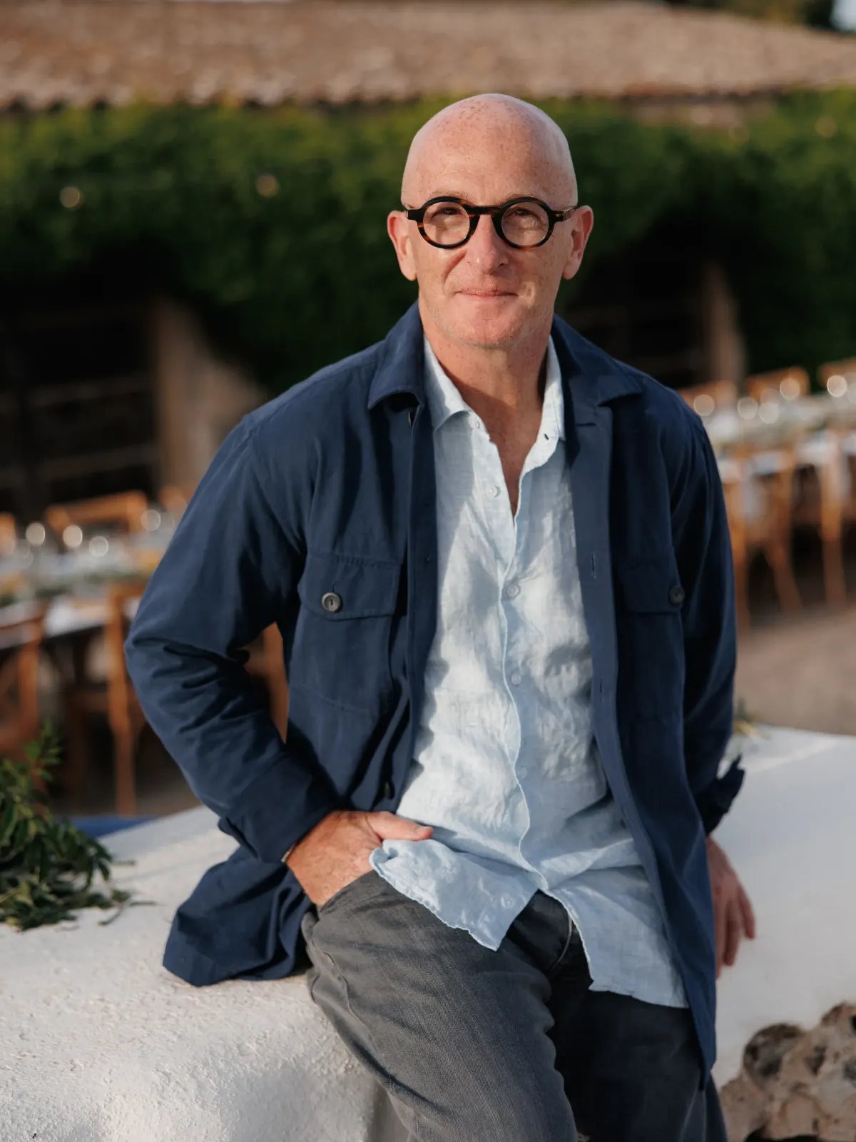 Outdoor dining, navy jacket over white linen.